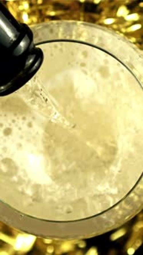 Champagne is Poured Into a Glass with Air Bubbles Top View Filmed is Slow Motion 1000 Frames Per