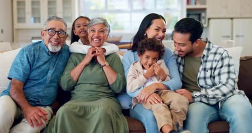 Happy Family Laughing Together on a Couch