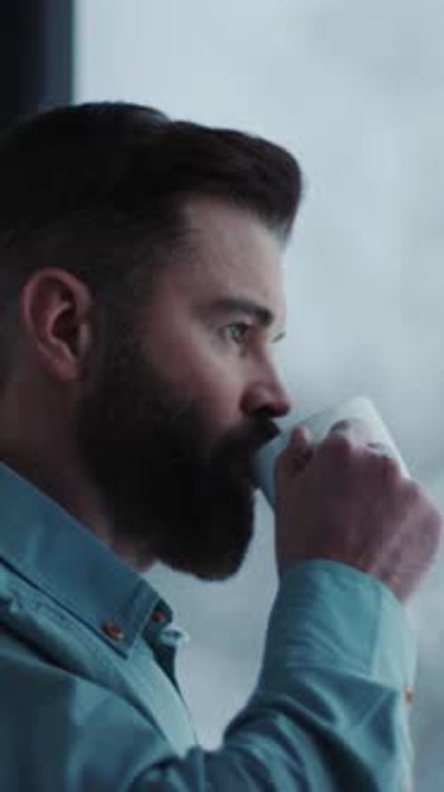 A Bearded Man Enjoys a Quiet Morning Sipping Coffee and Reflecting
