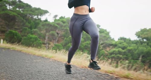 Woman, running and legs in exercise on mountain for marathon, training or outdoor workout in nature
