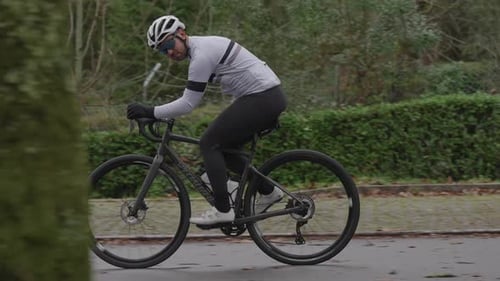 Slow motion cyclist riding road bicycle on park street