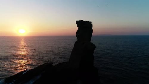 Rock Formation in the Sea at Sunset