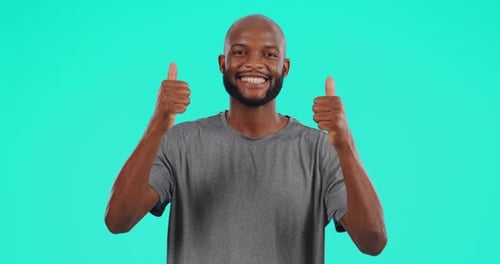 Happy, face and black man with thumbs up in studio isolated on a blue background mockup space