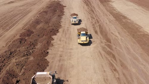Articulated hauler Truck loaded with Soil at an industrial development site.