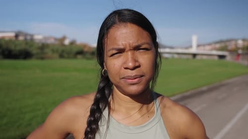 Serious Woman on Track on Bright Sunny Day