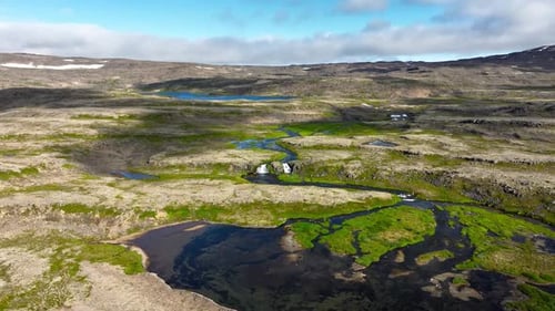 Flying Over the Beautiful Waterfall in Iceland on a Cloudy Summer Morning Landscape with Green Moss