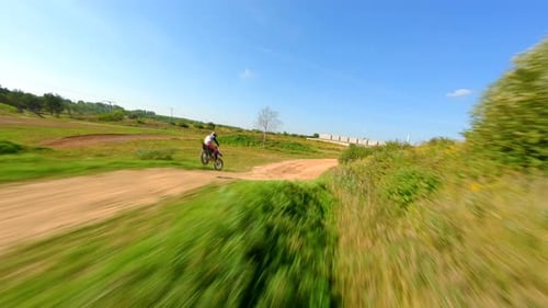 Motocross Rider on Dirt Bike on Rural Track