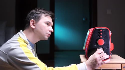 Man Changing Channels on Old Vintage TV Man Turning Channel Knob on Old Analog TV