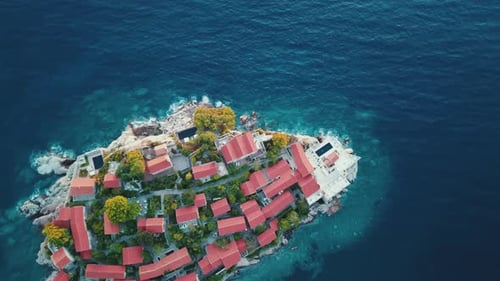 Aerial view of drone flying down and spin to the island of the Sveti Stefan in Montenegro, Balkans n