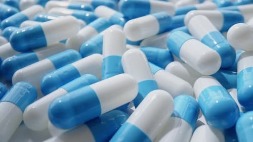 Pile of Blue and White Medicine Capsules