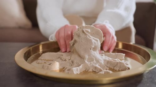 Lady Hands Molding Octopus Shape During Creative Therapy Activity