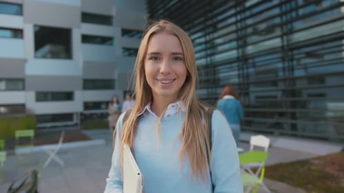 Portrait of Nice Caucasian Blonde Smiling Woman Young Student with Backpack Tablet Computer Near