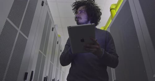 Young Adult Using Tablet in Server Room