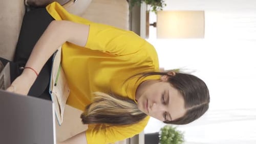 Young Woman Studying At Home With Laptop