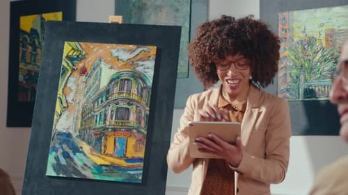 Woman Auctioneer Presents Cityscape Painting at Art Auction