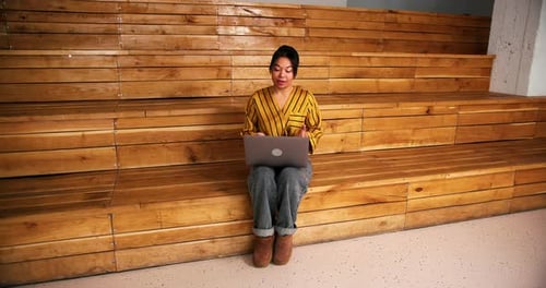Smiling Successful Hispanic Woman Using Laptop Working in Modern Office Having Video Call