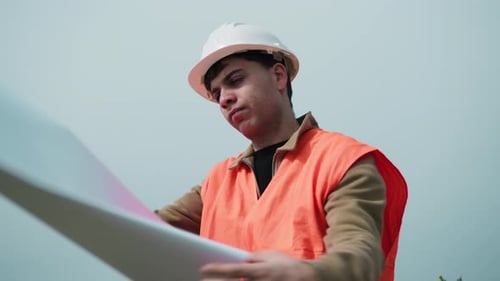 Engineer Taking A Look At The Project Map Outdoor
