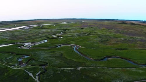 Beautiful aerial view of a meandering jungle river in the dense green vegetation along with it's tri