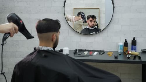 Barber Using Hair Dryer on Customer in Shop