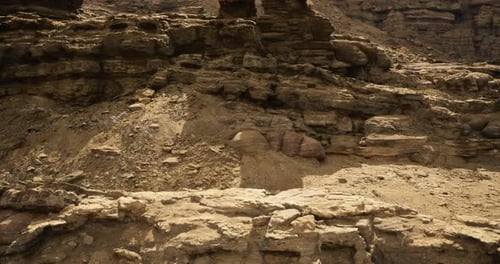 Eroded Rocky Terrain in a Sunlit Desert Landscape