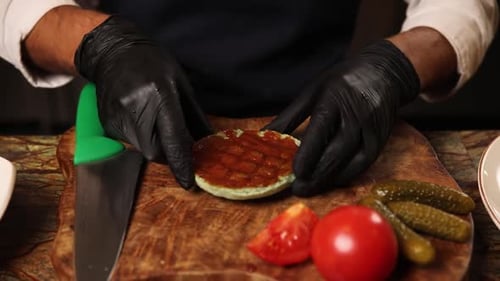 Hands preparing burger ingredients on wood
