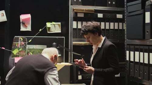 Investigators Working Together in a File-Filled Office