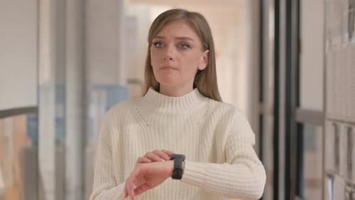 Waiting Young Woman Checking time on Smart Watch