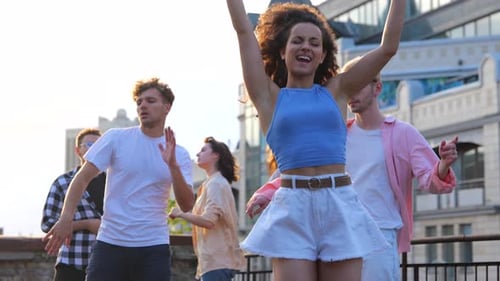 Friends Dancing Together on a City Rooftop