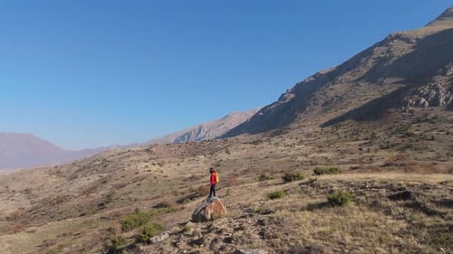 Aerial View Young hiker walking on a mountain path on a sunny day