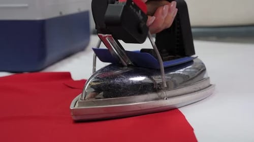 A Dressmaker Steams a New Tailored Dress on a Specialized Ironing Board