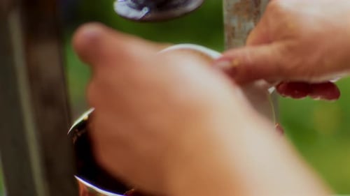 Hands Strain Mixture through Cloth