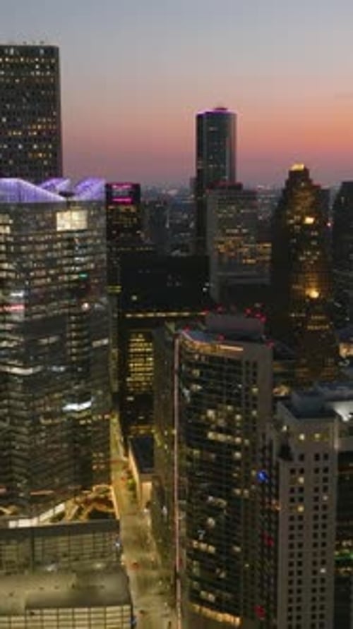 Portrait drone shot of illuminated downtown Houston, vibrant dusk in Texas, USA