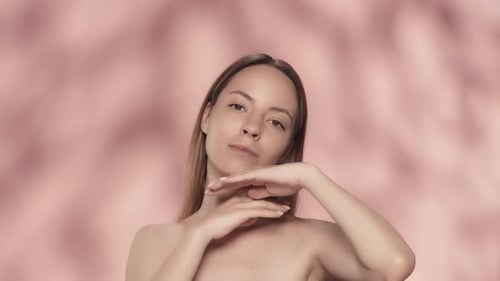 Young Woman Posing in Studio with Pink Backdrop