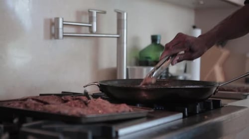 beef meat cocking grill in home kitchen black chef preparing meal