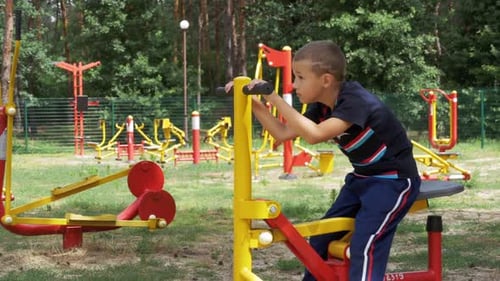 Child Boy Engaged on Sports Training Simulator at the Street