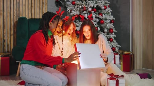 Friends Opening Magical Gift at Christmas Celebration