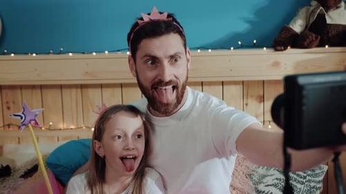 Father and Daughter Making Funny Faces for Camera