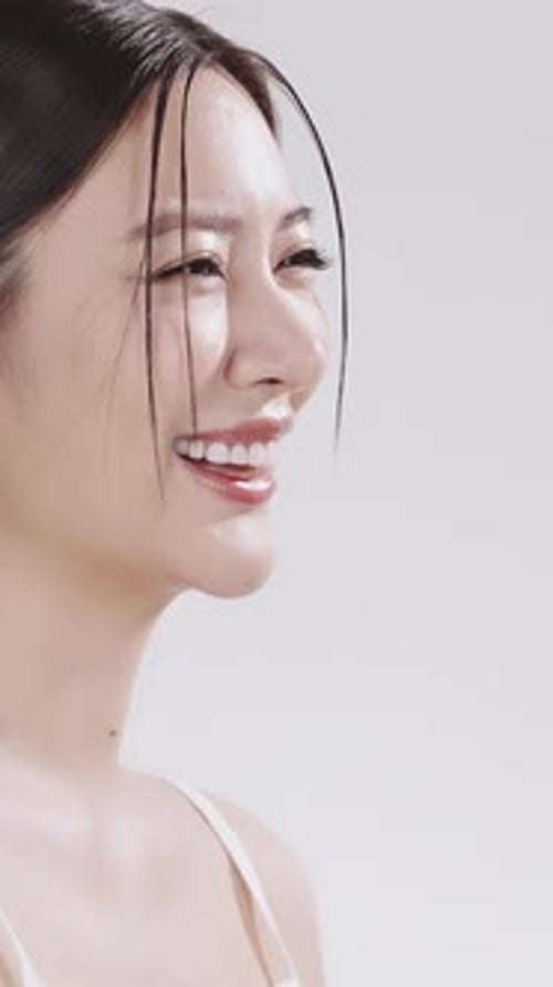 Beautiful Woman Poses and Smiles in Studio