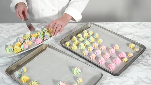 Step By Step Freshly Baked Unicorn Meringue Cookies on a Baking Sheet with a Parchment Paper