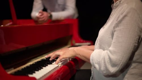 Woman Plays a Red Piano
