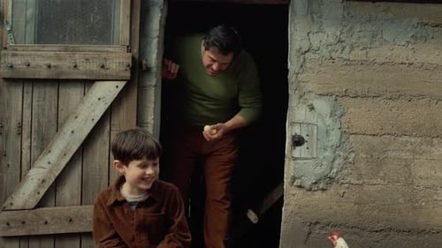 Farmer Father and Son Sitting at Coop Entrance Watching Chickens