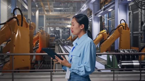Woman Using Tablet in Advanced Robotics Factory