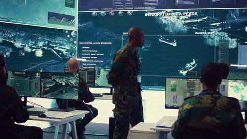 Military Team Monitors High Tech Data in Control Room