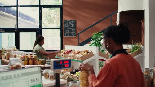 Regular Client Looking at Produce and Bulk Items in Eco Store