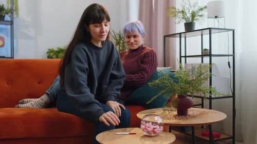 Two Women Excitedly React to Pregnancy Test Result