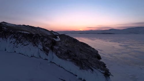 Aerial Over the Rocky Island in Lake Baikal Winter Landscape of Frozen Baikal at Beautiful Lilac
