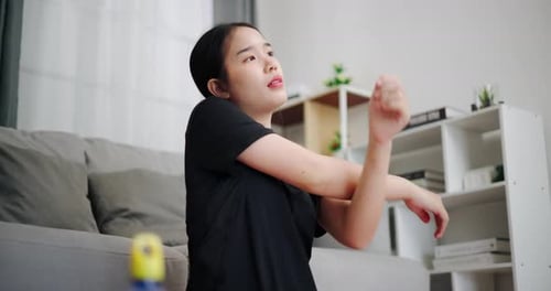 Woman Stretching Arms in Living Room