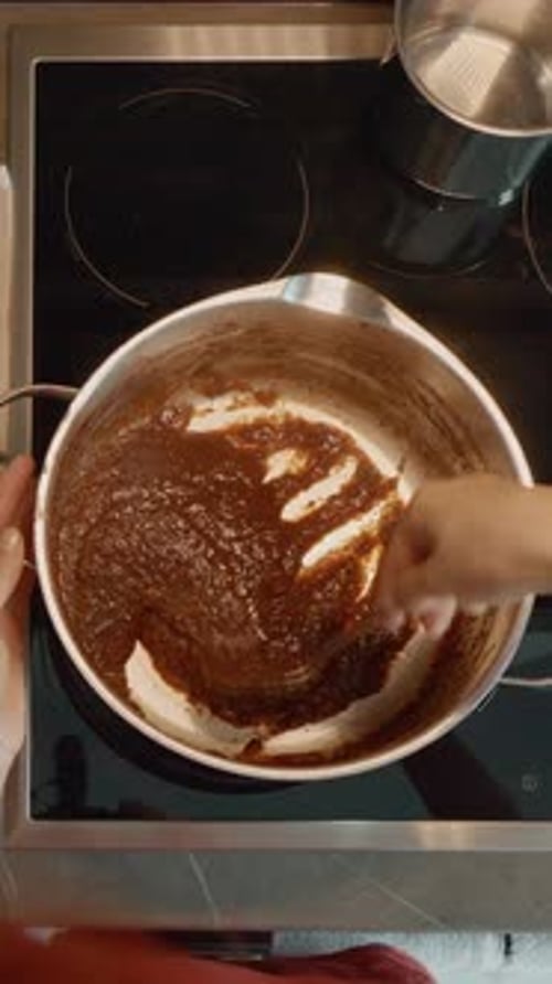 Close up of chef stirring sauce on stove