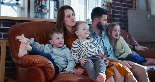 Happy Family Relaxing on Couch at Home