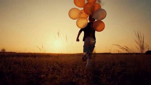 Child Runs with Balloons in Sunset Field